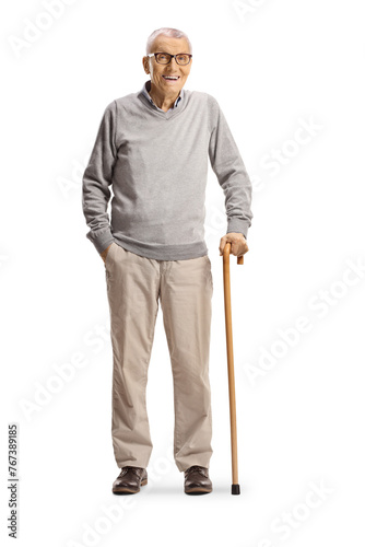 Elderly gentleman standing with a cane and smiling