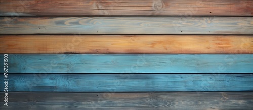 A closeup of a hardwood plank wall with a rainbow of wood stain tints and shades creating a beautiful pattern on the building material