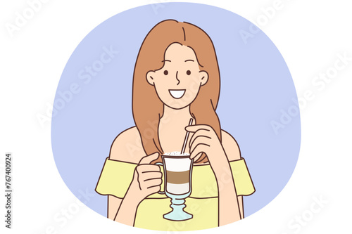 Smiling woman drinking late coffee with straw