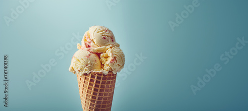 Delicious scoops of strawberry ice cream in a crispy waffle cone against a soft blue background