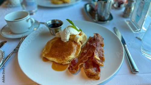 Buttermilk pancakes, bacon and coffee breakfast at a restaurant on a cruise ship.