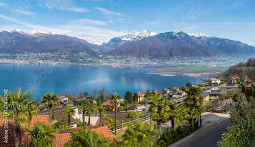 Tableau sur toile Landscape of Lake Maggiore with Fosano village and mountains in background, Vira