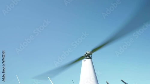 Main rotor blades of helicopter rotating against blue sky background, helicopter blades in motion, powerful engine of aircraft keep moving rotor blades while taking off or landing