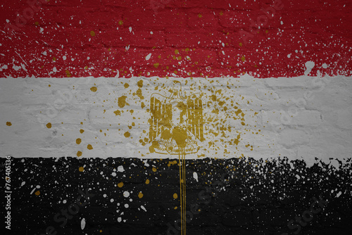 colorful painted big national flag of egypt on a massive brick wall