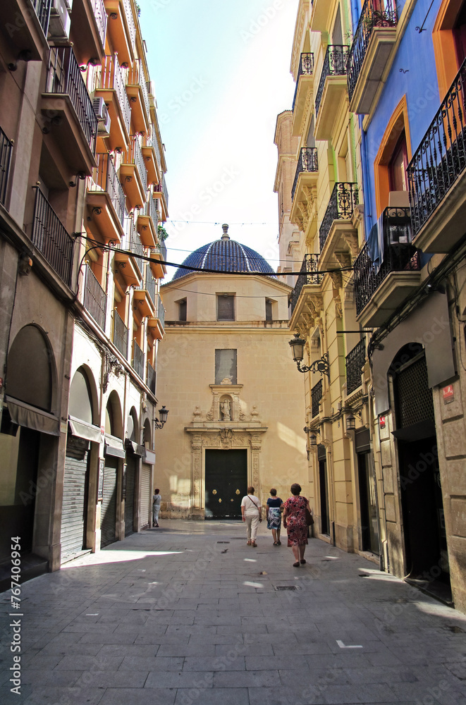 Old ladies walking along San José street in Alicante, towards the St. Nicolás de Bari church.