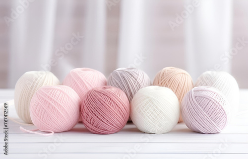colorful balls of thread and metal knitting needles on a white w