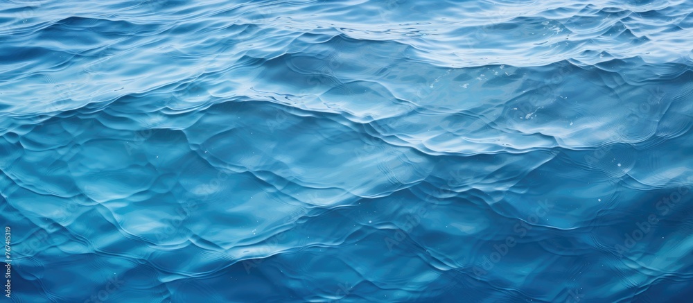 Obraz premium A close-up view of a small boat sailing on the gentle waves of a vast blue ocean