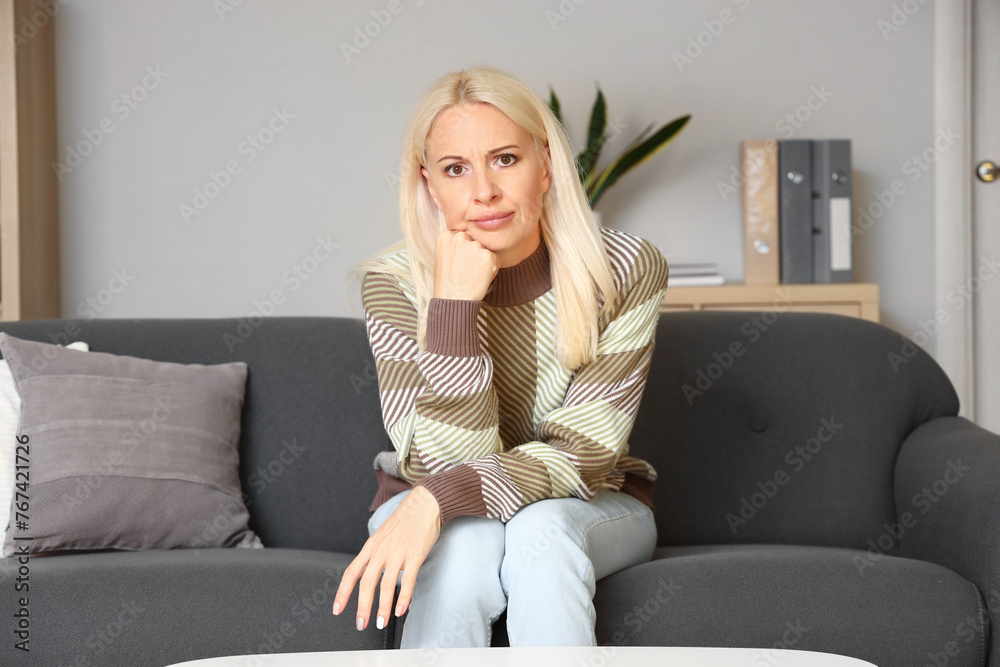 Obraz premium Mature woman video chatting at home