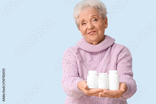 Senior woman with pill bott...