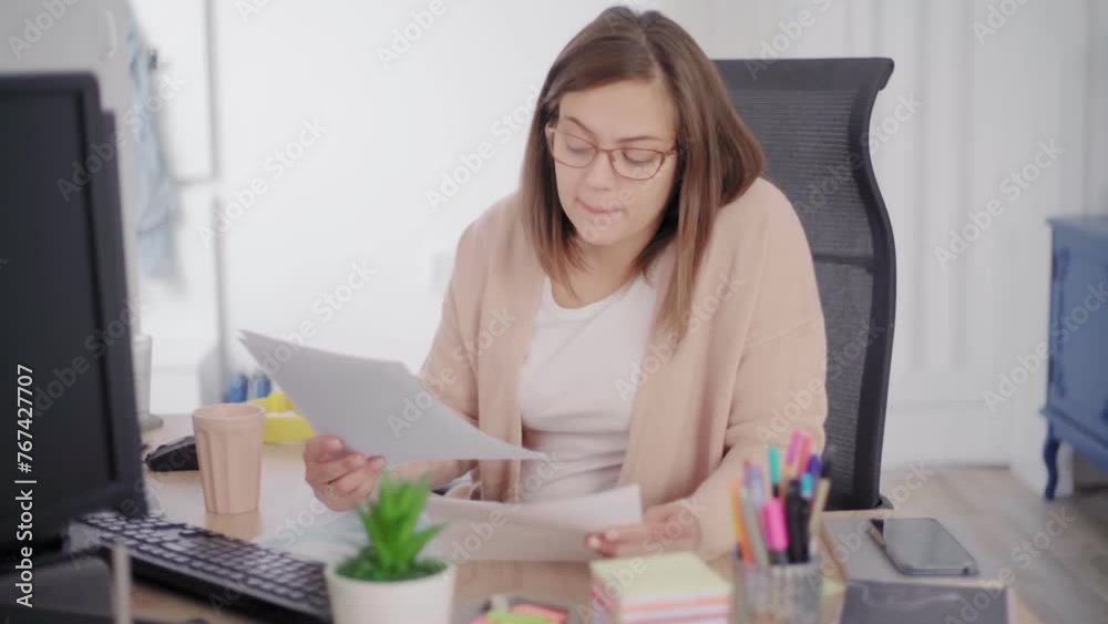 A woman sitting by a computer and working on personal finance at home A woman sitting by a computer and working on personal finance at home