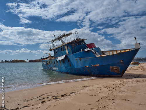 Storm's Aftermath: Iron Boat Stranded on Ferragudo Coastline, Algarve.