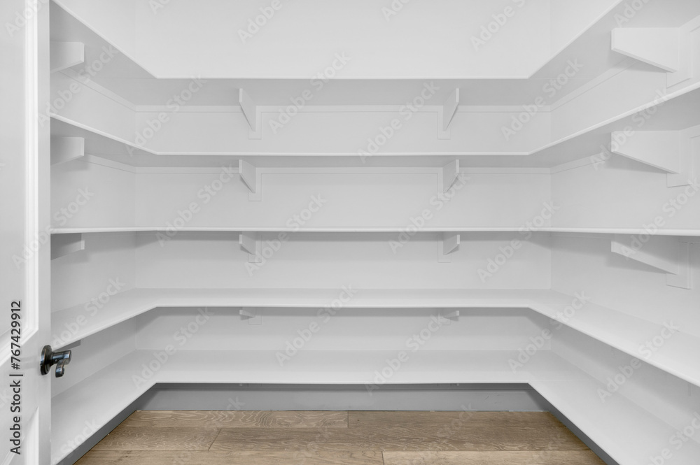 Spacious white pantry with empty shelves Spacious white pantry with empty shelves