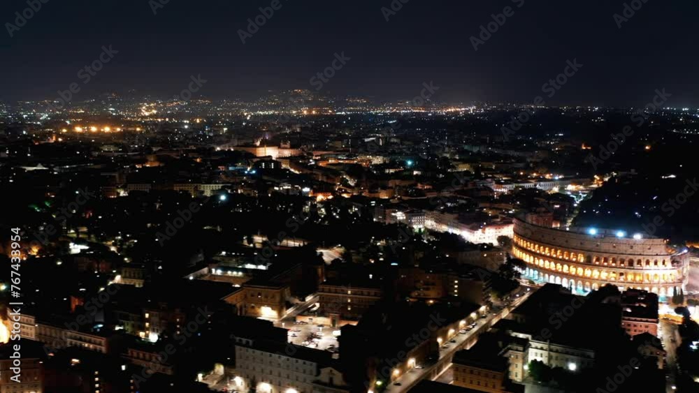 Aerial Timelapse: Illuminated Colosseum Amidst Buildings In City At Night - Rome, Italy Aerial Timelapse: Illuminated Colosseum Amidst Buildings In City At Night - Rome, Italy