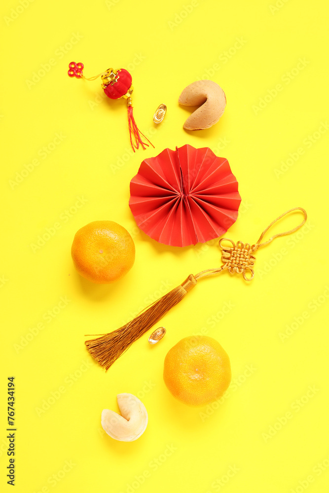 Fortune cookies with mandarins and Chinese symbols on yellow background. New Year celebration Fortune cookies with mandarins and Chinese symbols on yellow background. New Year celebration