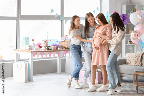 Female friends touching bel...
