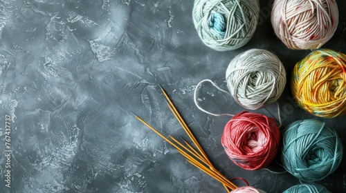 Top view group of woolen knitting yarns balls and needles on grey background. AI generated image