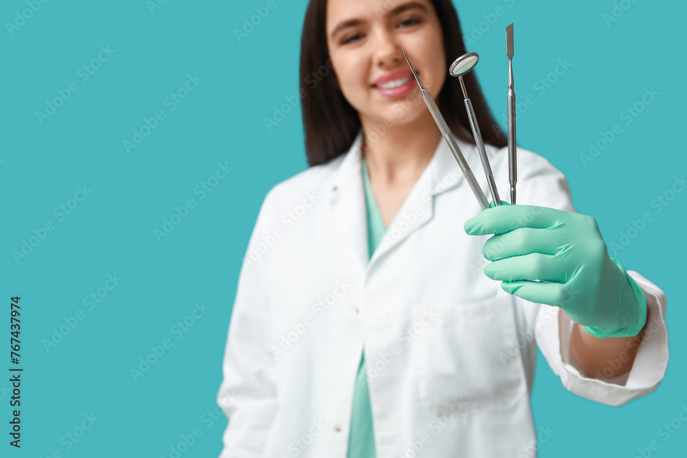 Female dentist with tools on blue background. World Dentist Day Female dentist with tools on blue background. World Dentist Day