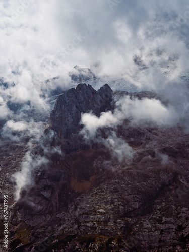 Side wall of Marmolada mountain in clouds, Dolomites, Italy