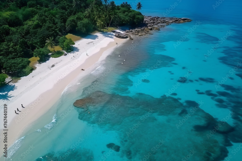 Sandy beach with clear blue waters seen from above.