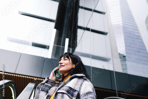 Cheerful Woman on Call with Urban High-Rises