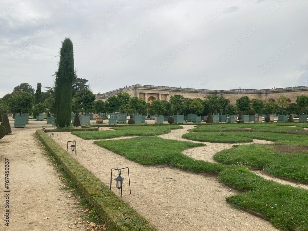 Versaille Palace tree lined pathways with symmetrical layout of gardens 