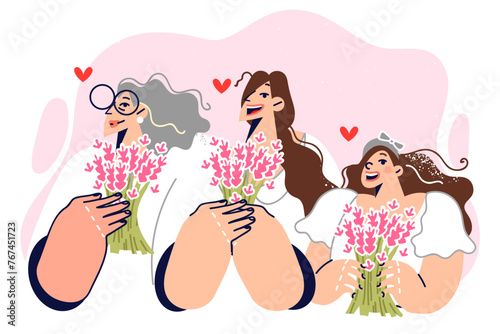Family of women of different generations with flowers celebrate march 8 or mother day