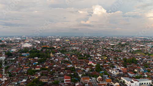 a bird's-eye view of Yogyakarta, with the cloud-covered Merapi volcano in the background