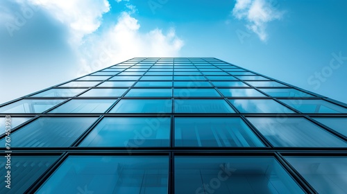 Urban Majesty: Bottom-Up Shot of City Skyscraper Against Blue Sky and Clouds