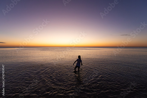 person on the beach at sunset © Chris Jiacheng Sun