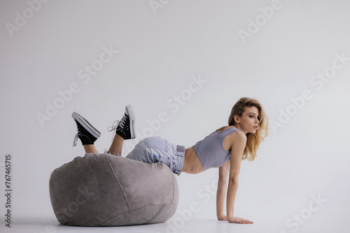 Portrait of an attractive young girl lying on a bean bag chair, coworking, vacation, lifestyle