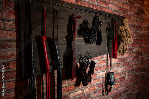 A set of BDSM equipment hanging on the wall. 
