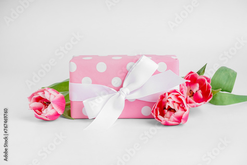 Fototapeta Naklejka Na Ścianę i Meble -  Gift box with beautiful tulip flowers on white background
