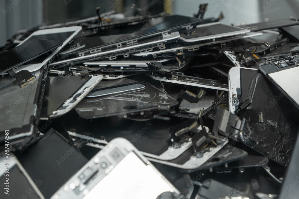 A heap with the broken screens lying one on top of another. Devices are prepared for utilization A heap with the broken screens lying one on top of another. Devices are prepared for utilization