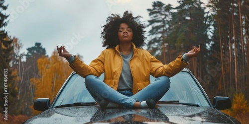 Woman meditating on top of her car in nature #767484132