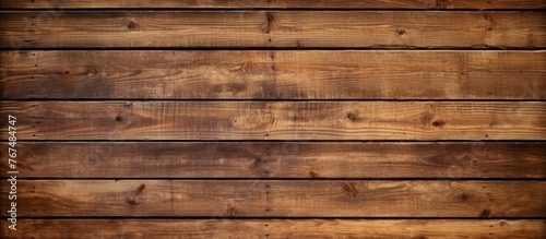 A closeup shot of a brown wooden wall made of rectangular wooden planks with a hardwood flooring pattern in beige wood stain