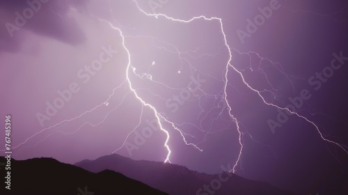  a purple sky with a large amount of lightning in the sky and a mountain in the foreground with mountains in the foreground.