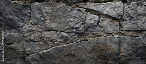 A detailed view of a stone wall made up of various rocks, showcasing the intricate patterns and composite materials formed by bedrock intrusion