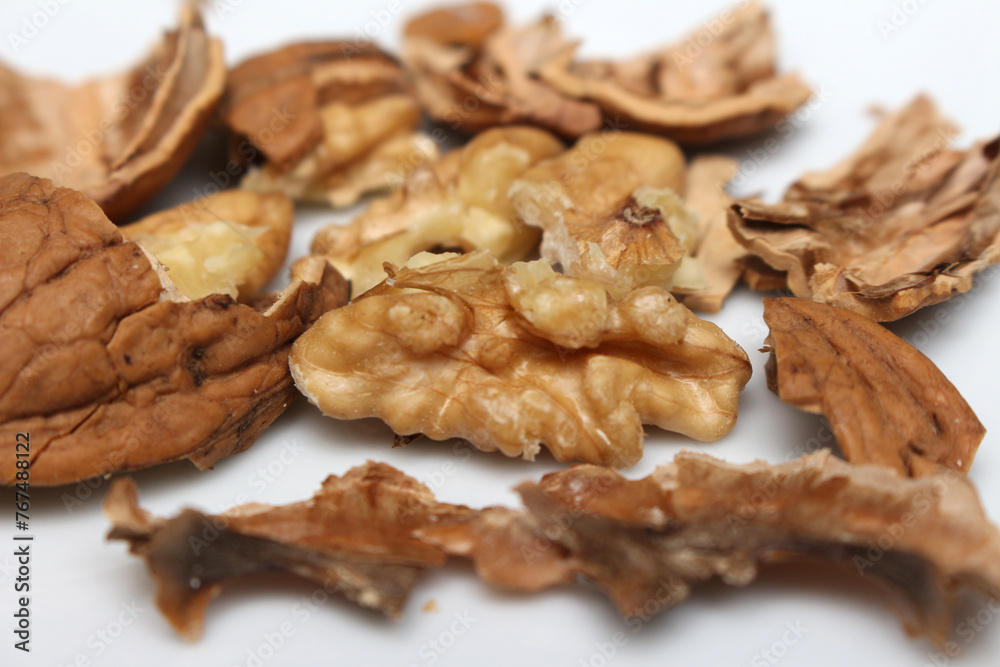 cracked walnut. scattered walnut shells. fruit with hard skin. cracked walnut. scattered walnut shells. fruit with hard skin.
