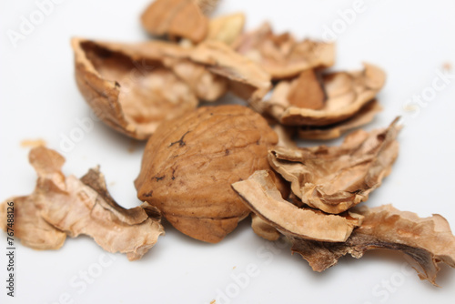 cracked walnut. scattered walnut shells. fruit with hard skin.