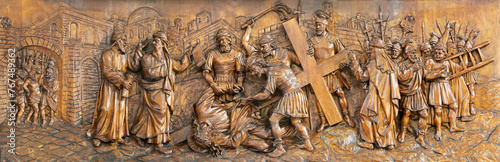 MILAN, ITALY - MARCH 5, 2024: The carved relief of Fall of Jesus under the cross in the church Chiesa di San Camillo by Annibale Pagnoni (1900).