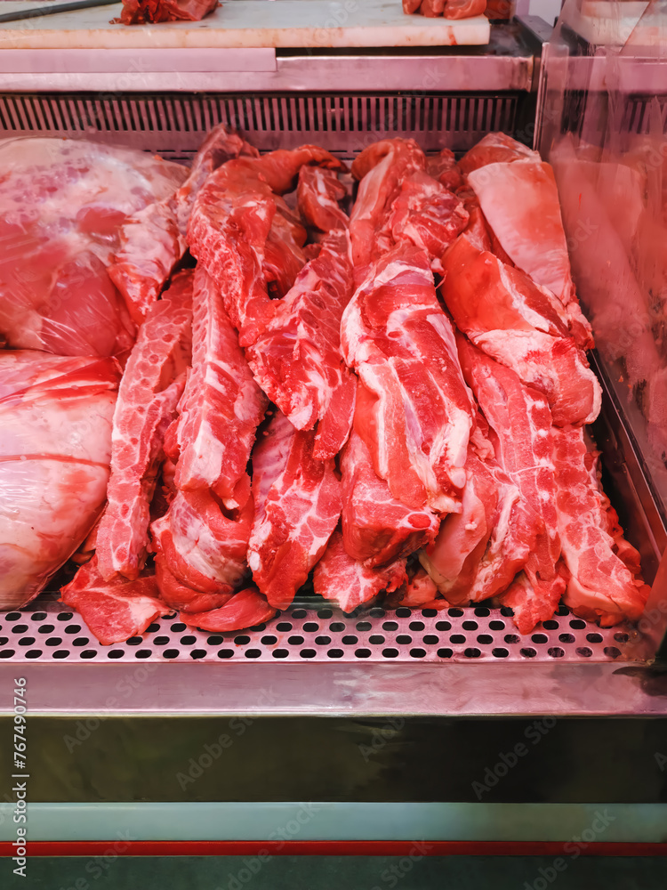 Pork rib meat in a butcher shop refrigerator, rich food with protein, shopping in local market