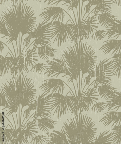 Seamless pattern with silhouettes of palm trees with vintage aged texture. Vector floral background. Delicate gray-green color.