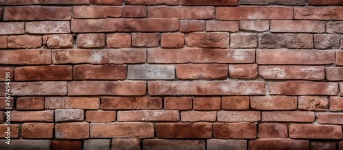 A closeup of a brown brick wall showcasing the rectangular shape of each brick. The brickwork creates a symmetrical facade, highlighting the building materials composite nature