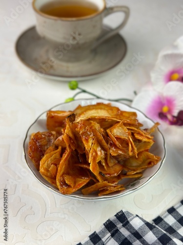 A Malay traditional snack named Kerepek Ubi Pedas Basah. This is local Asian junk food dried and fried cassava slices. photo