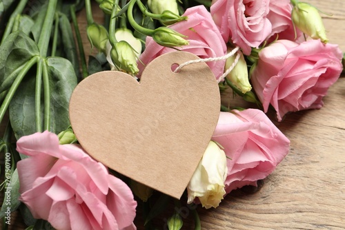 Happy Mother's Day. Beautiful flowers and blank heart shaped card on wooden table, closeup