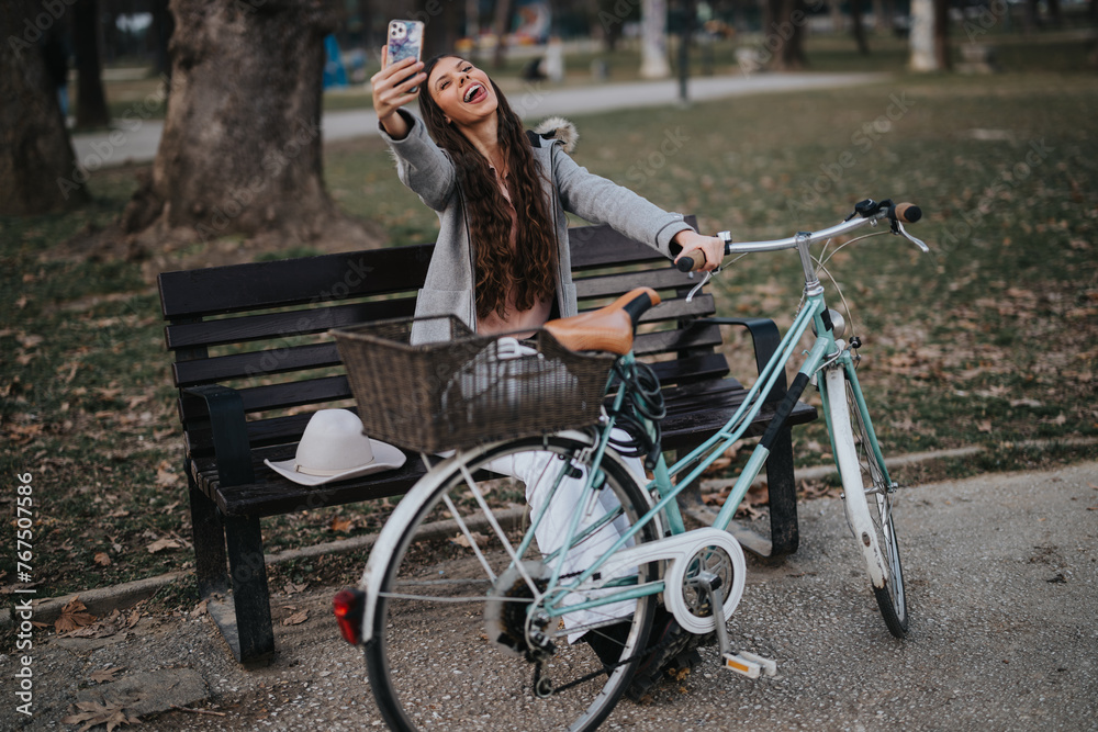 Obraz premium A businesswoman enjoying a moment of relaxation in the park with her bicycle and a hat resting on the bench.