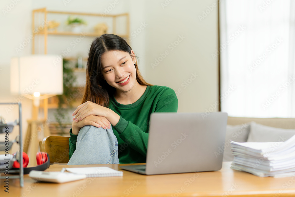 Ambitious Asian girl working from home Looking at laptop screen and smiling, checking mail or doing research while working remotely, online startup business, telemarketing Ambitious Asian girl working from home Looking at laptop screen and smiling, checking mail or doing research while working remotely, online startup business, telemarketing