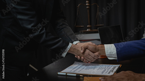Law and justice concept, businessman shaking hands with lawyer to seal agreement with lawyer, partner or lawyer discussing contract agreement The concept of holding hands. Close-up.