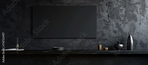 Wall painted black with a shelf and a black poster.