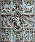 MILAN, ITALY - SEPTEMBER 16, 2024: The detail from main bronze gate of the Cathedral - Deposition (Pieta) by Ludovico Pogliaghi (1906).